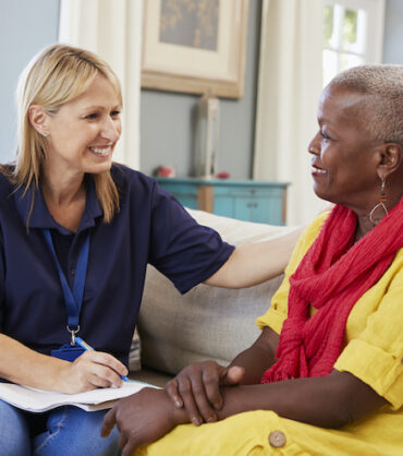 Female Support Worker Visits Senior Woman At Home